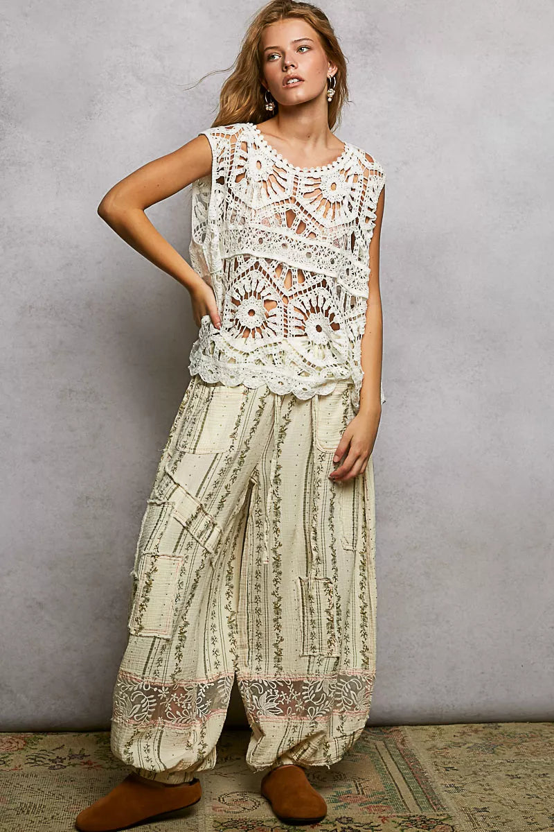 Woman in POL Openwork Round Neck Floral Crochet Tank with wide patchwork pants