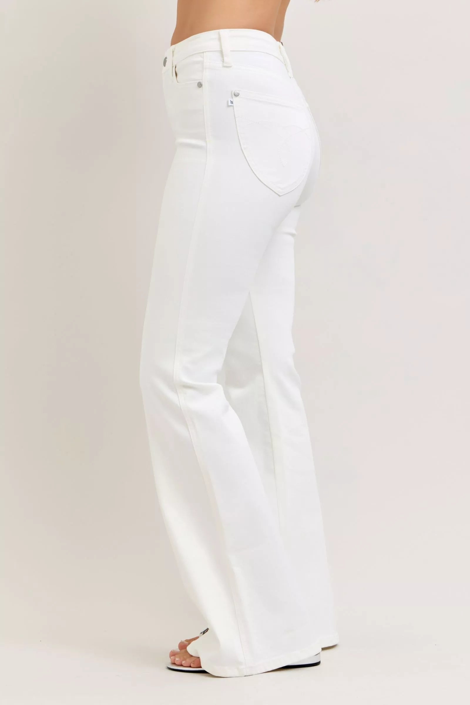 White Judy Blue high-waisted tummy control flare jeans with minimalist design