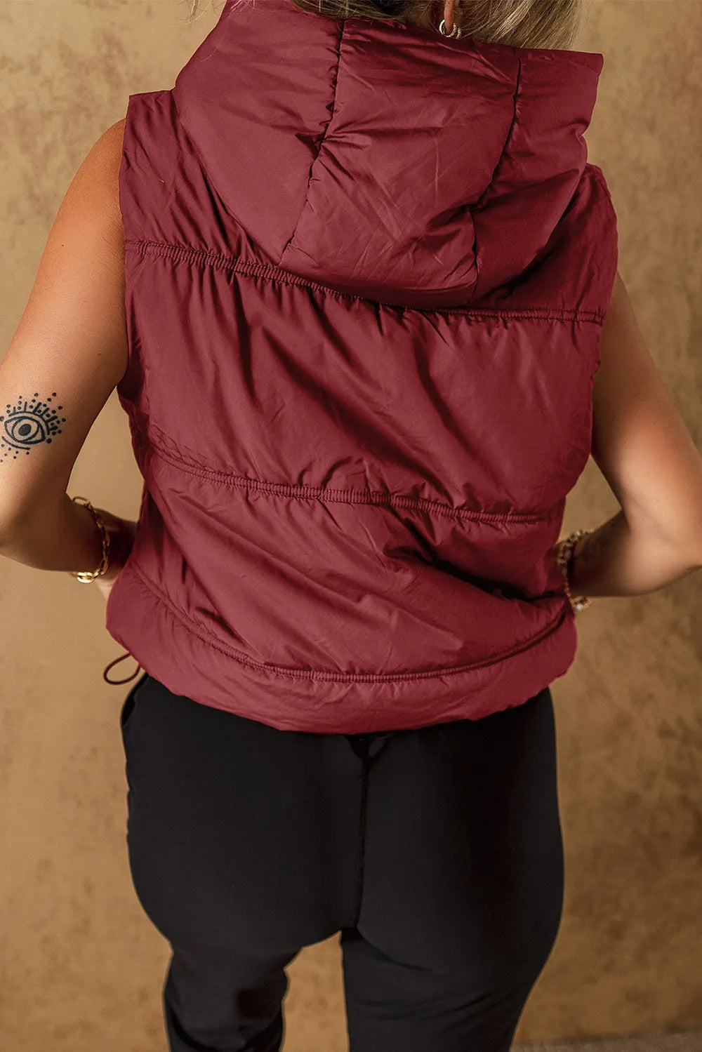 Puffy maroon sleeveless drawstring zip-up hooded vest coat with horizontal stitching
