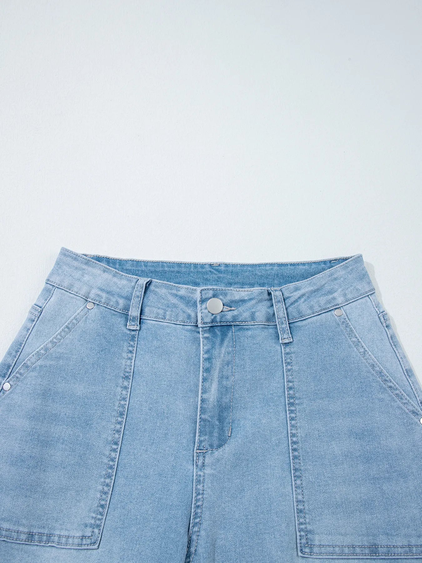 Light blue high-rise barrel relaxed denim shorts with button fly and patch pockets