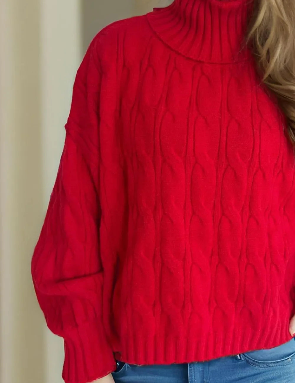 Red cable-knit turtleneck sweater with balloon sleeves