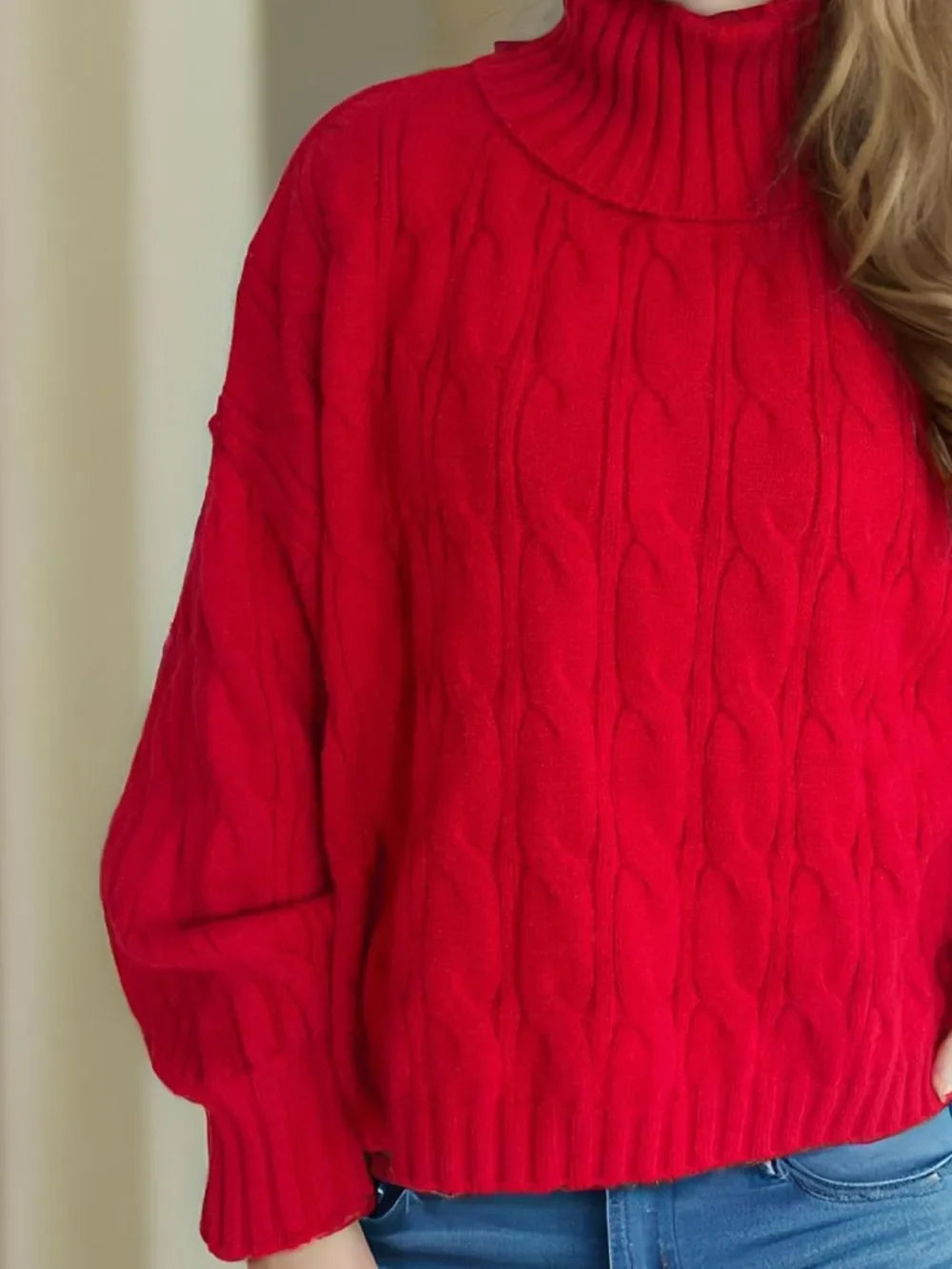 Red cable-knit turtleneck sweater with balloon sleeves