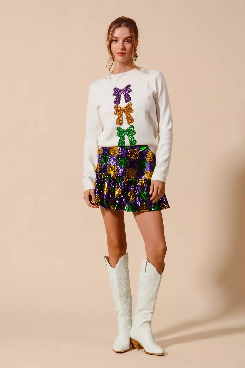 White long-sleeved sweater with purple, gold, green sequined bows for SO ME Mardi Gras skirt