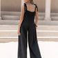 Black sleeveless wide-leg jumpsuit with tie shoulder bows