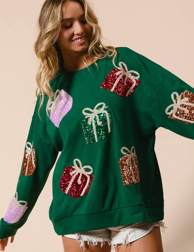 Green sequined gift box sweater with pastel accents and lace hem