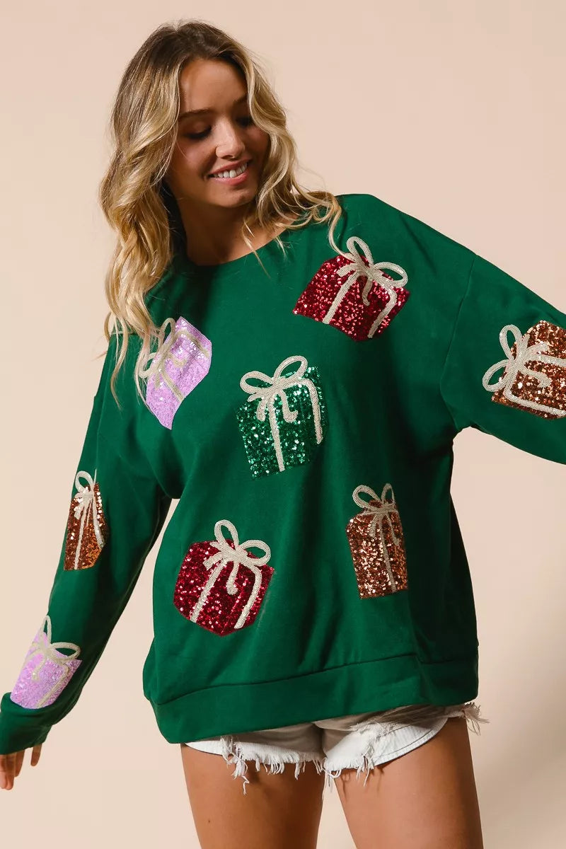 Green sequined gift box sweater with pastel accents and lace hem