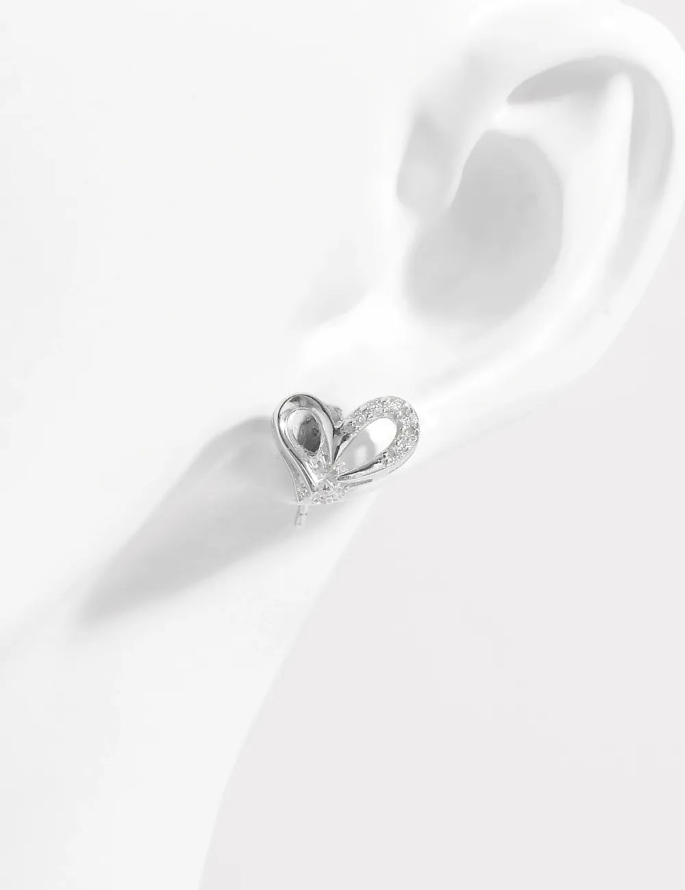 Silver heart-shaped stud earring with diamond accents