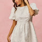 White textured mini dress with puff sleeves and floral jacquard gathered waist