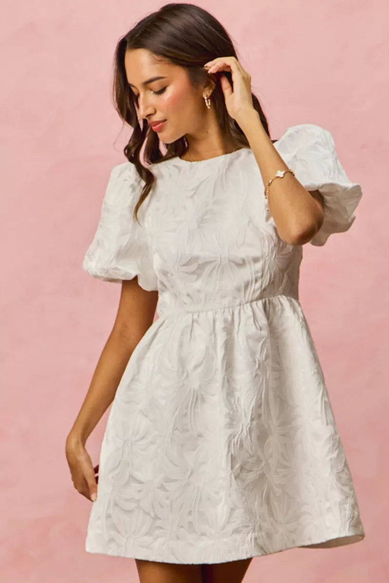 White textured mini dress with puff sleeves and floral jacquard gathered waist