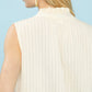 Umgee sleeveless textured split neck top in cream with pleats and ruffle neck