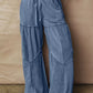 Blue denim tiered wide-leg pants with drawstring waist and patchwork