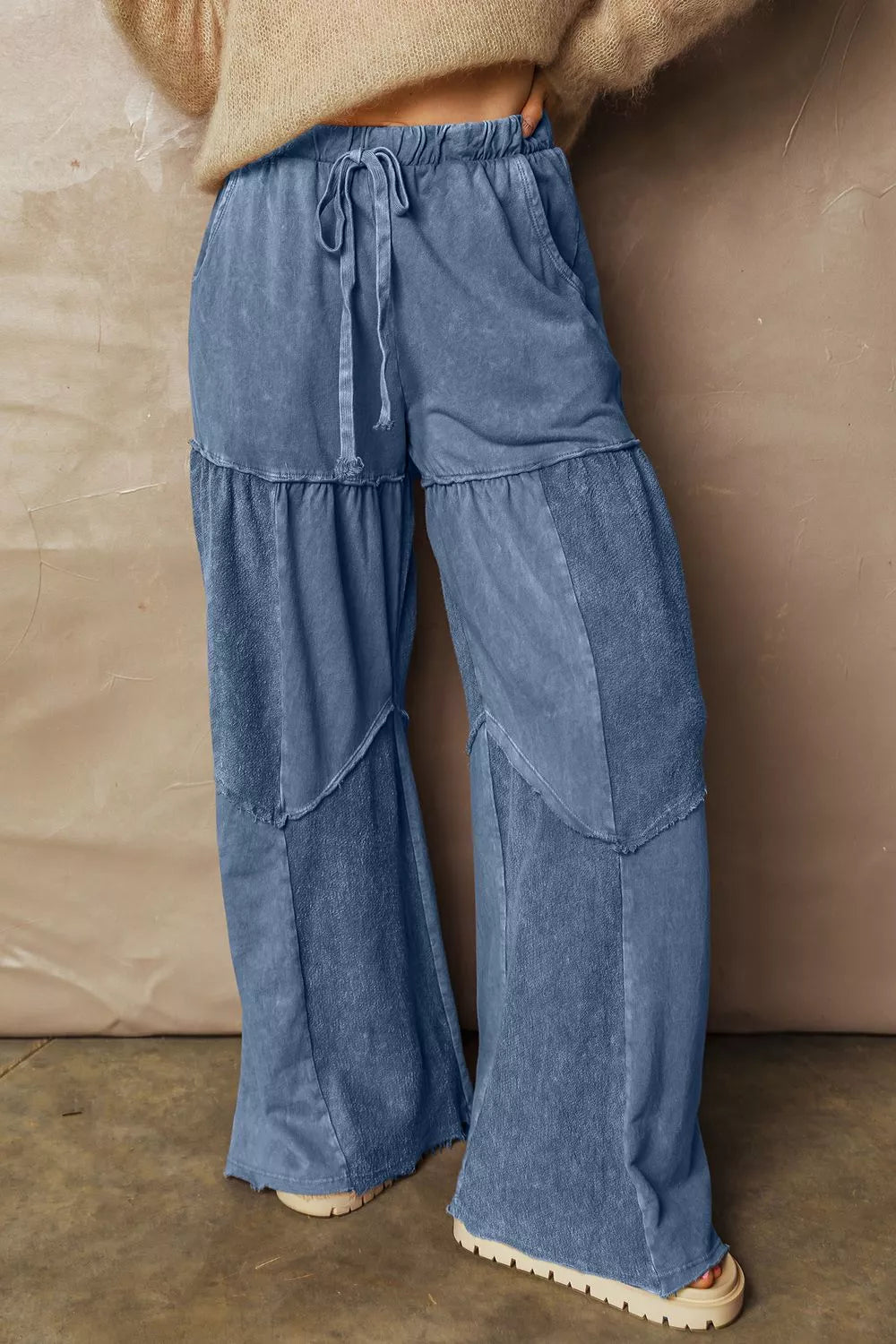 Blue denim tiered wide-leg pants with drawstring waist and patchwork