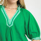 Vibrant green Umgee French Terry top with V-neck lace trim and puffed sleeves