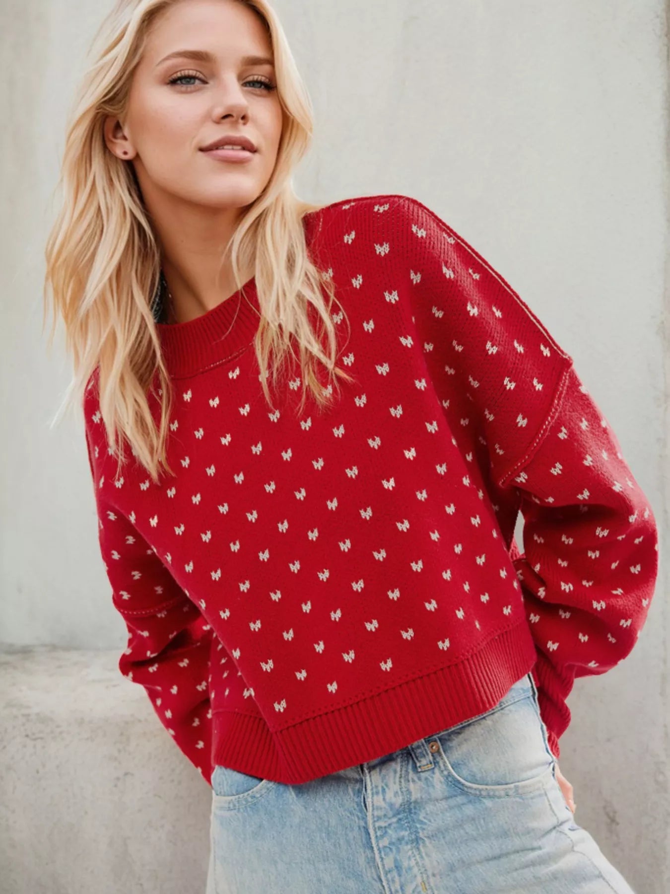 Daverri red knit sweater with white butterfly pattern and ribbed cuffs