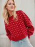 Daverri red knit sweater with white butterfly pattern and ribbed cuffs