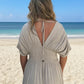 Beige flowing full-size deep V-neck maxi dress with back tie, smocked waist, and side slit from Daverri Fashions