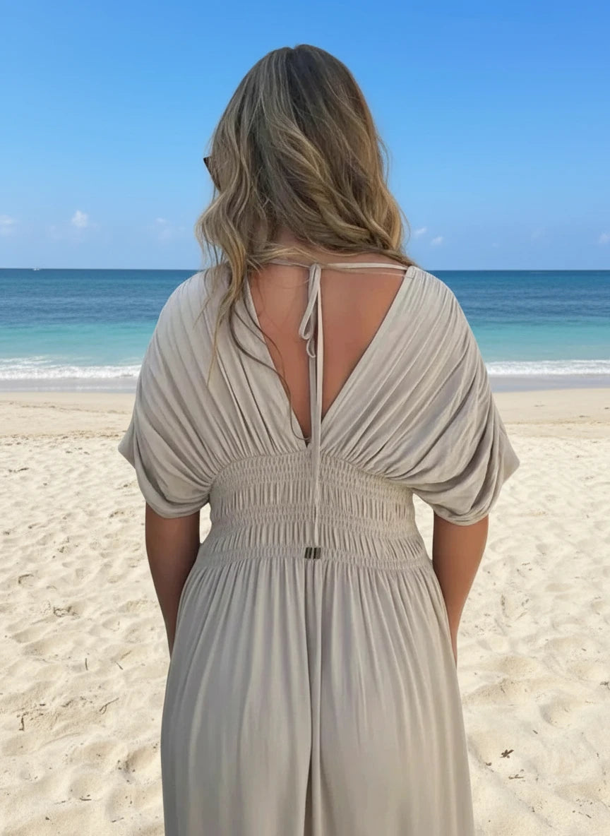 Beige flowing full-size deep V-neck maxi dress with back tie, smocked waist, and side slit from Daverri Fashions