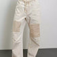 Daverri Washed Relaxed Fit Barrel Jeans in off-white denim with beige patchwork and paint splatters