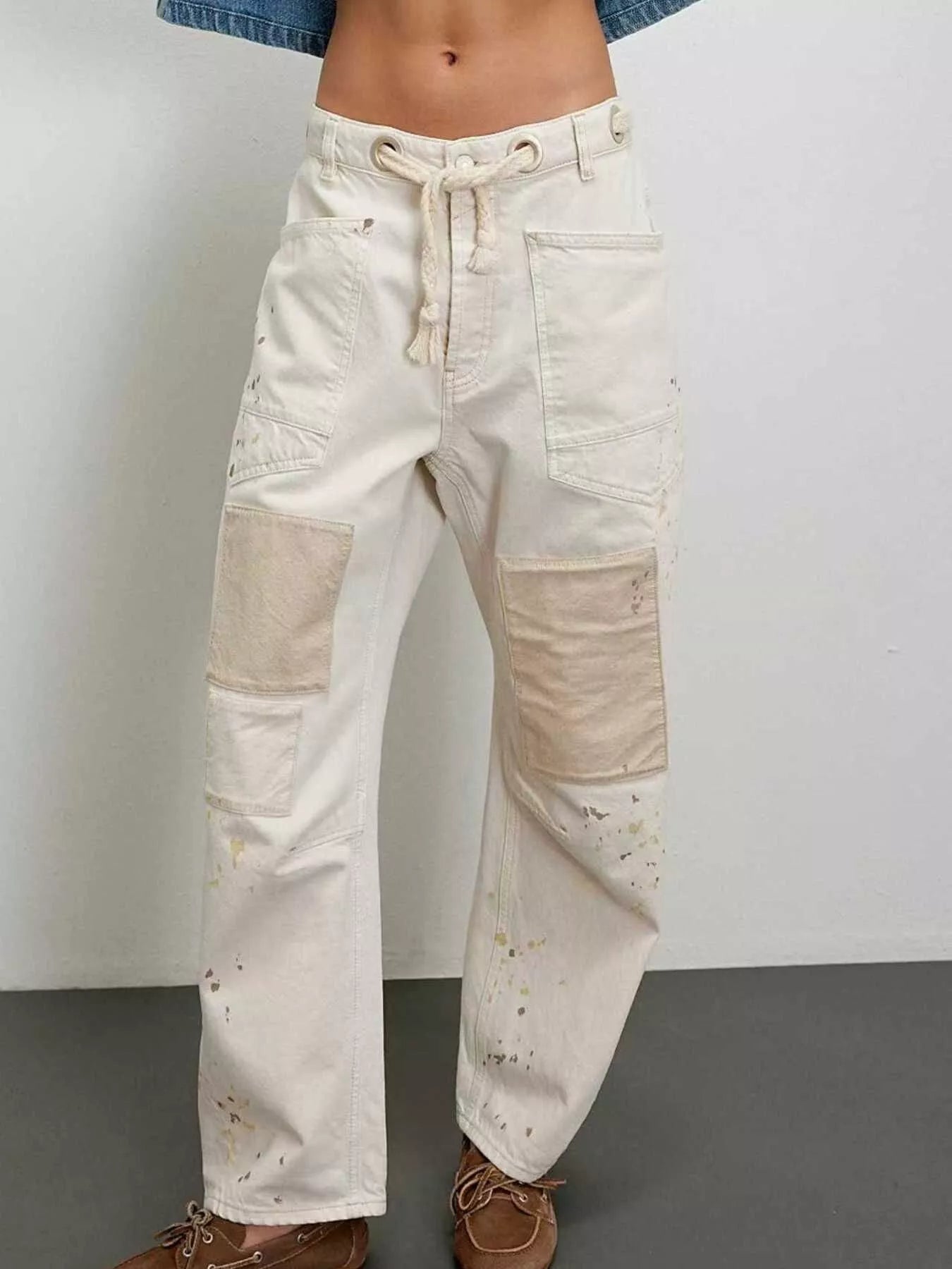 Daverri Washed Relaxed Fit Barrel Jeans in off-white denim with beige patchwork and paint splatters