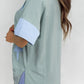 Light blue frayed denim oversized T-shirt with star patch and striped cuffs
