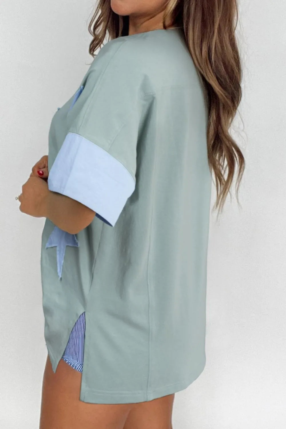 Light blue frayed denim oversized T-shirt with star patch and striped cuffs