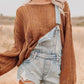 Distressed denim overalls shorts with light-wash frayed hem over brown herringbone sweater