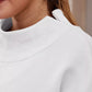 White mock neck dropped shoulder sweatshirt with ribbed collar