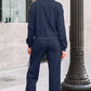 Women’s navy blue crewneck sweatshirt and sweatpants set with white striped side panels