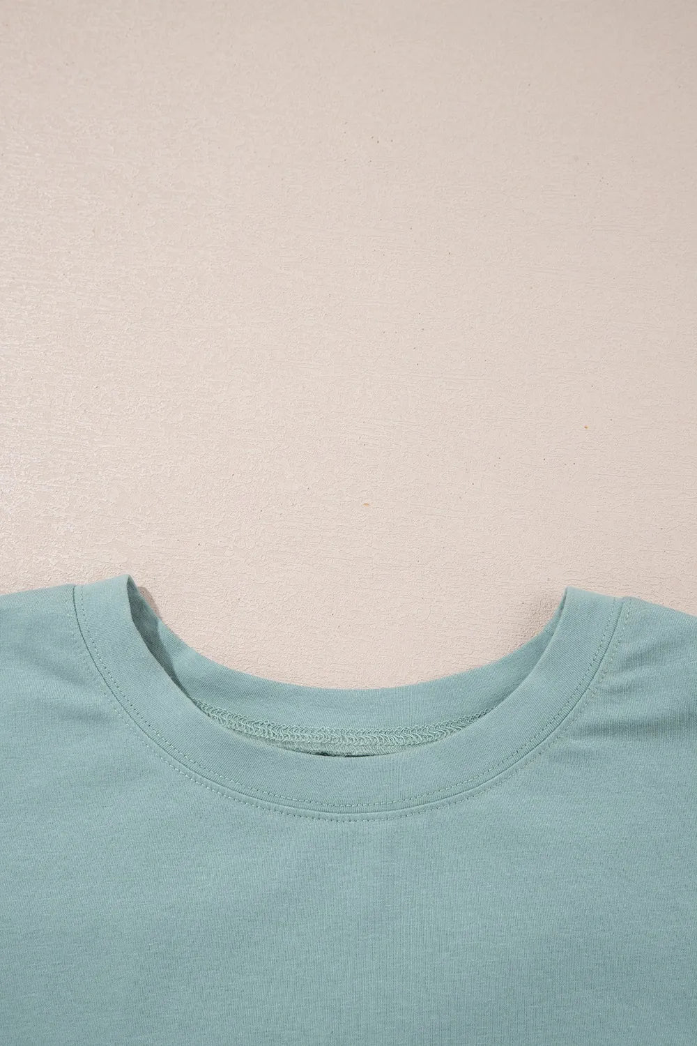 Oversize mint green cotton t-shirt with frayed denim star patch