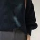 Black ribbed knit oversized turtleneck sweater with voluminous sleeves