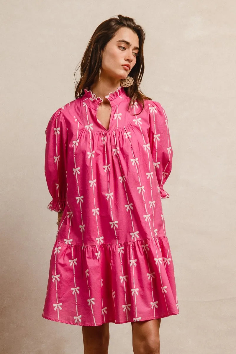 Vibrant pink BiBi ribbon pattern dress with white bows, puffed sleeves, scalloped edges