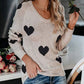 Soft beige knit Heart Scoop Neck sweater with black heart patterns