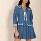 Blue pleated mini dress with Peter Pan collar and tie front