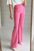 Bright pink high-waisted bootcut pants with flared tailored fit