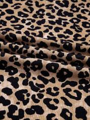 Leopard print long sleeve hoodie with pocket, tan fabric and black spots