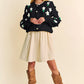 Black Davi & Dani cropped cardigan with puff sleeves, white floral embroidery, green leaves