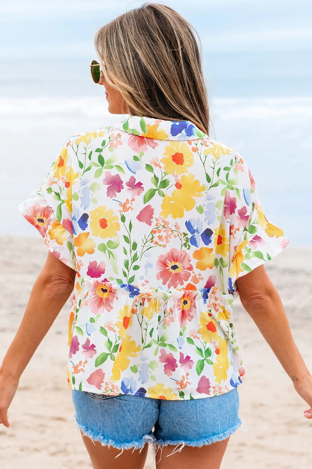 Floral boxy fit ruffled short sleeve blouse with vibrant blossoms