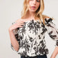 White smocked off-shoulder floral print blouse with puff sleeves