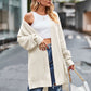 Cream-colored oversized waffle-knit cardigan with open shoulders