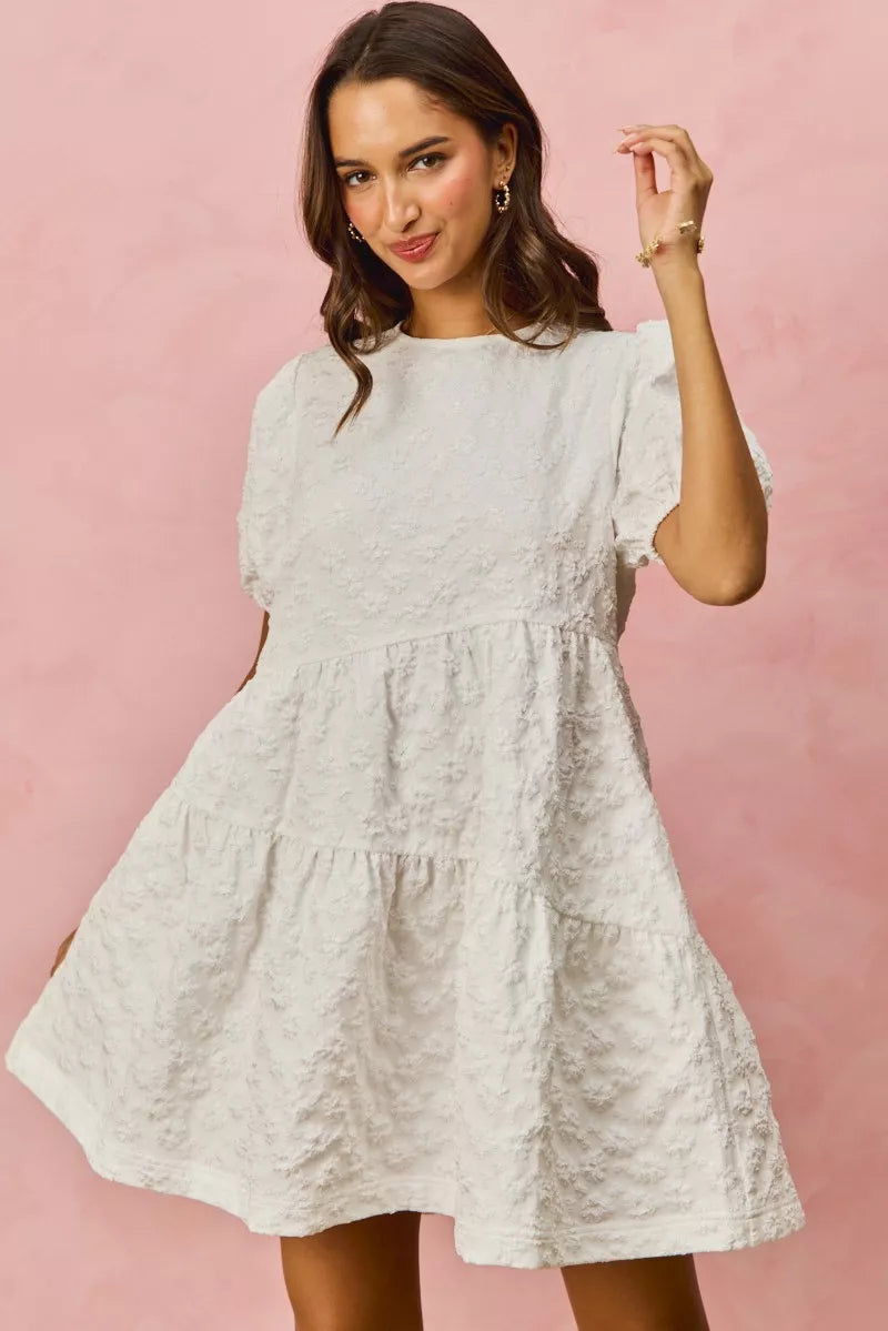 White textured SO ME floral jacquard diagonal tiered short mini dress with puffed sleeves and gathered waist