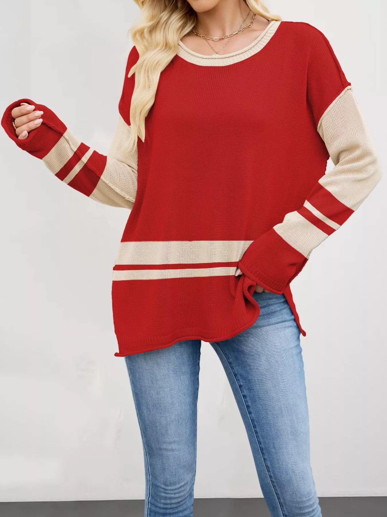 Red and cream color block side slit knit sweater with ribbed trim