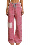 Daverri striped wide-leg pants with red-white stripes and thigh patchwork