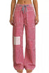 Daverri striped wide-leg pants with red-white stripes and thigh patchwork