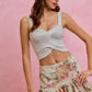 Light gray crocheted crop top with twisted front over SO ME floral skirt