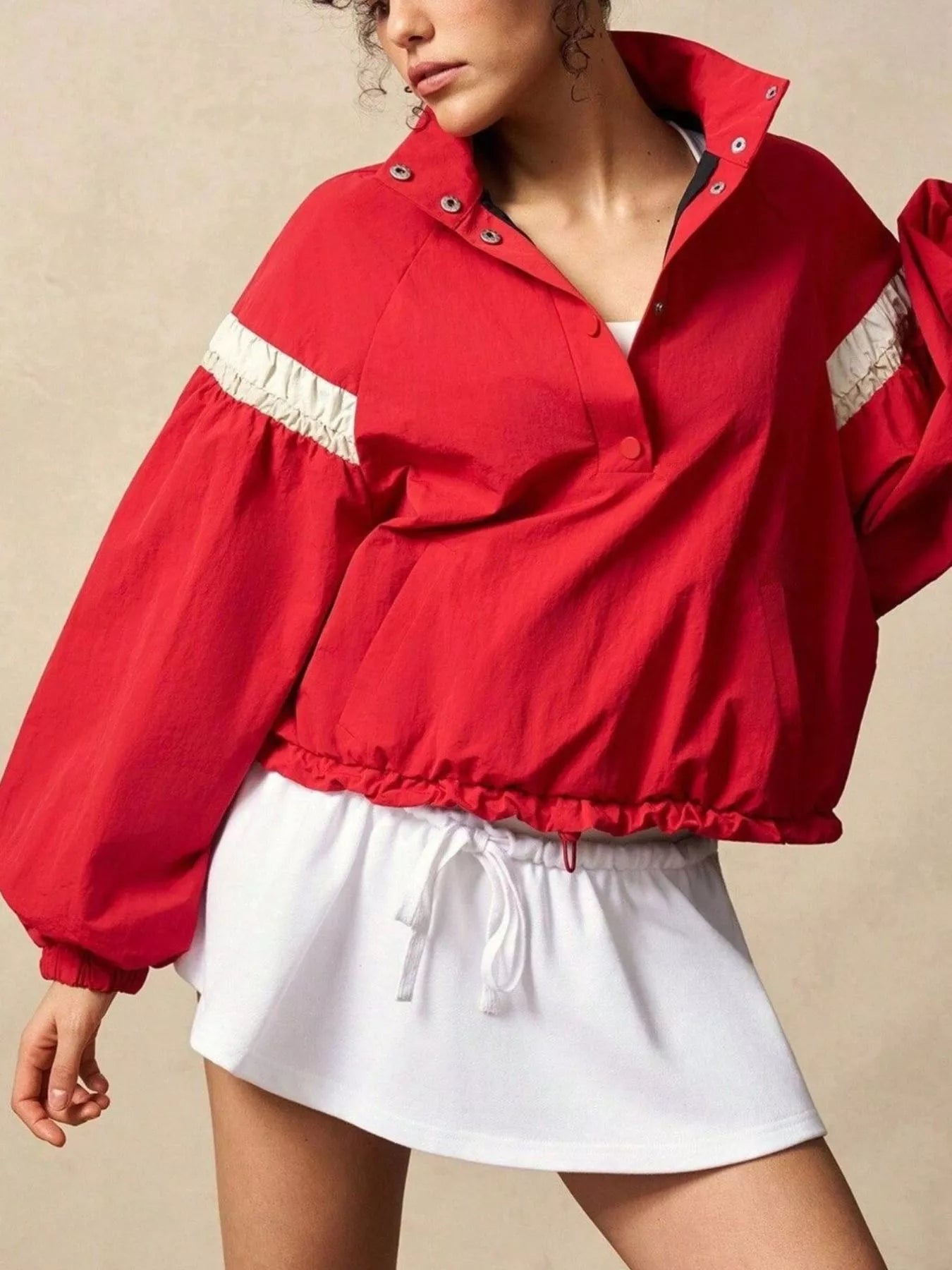 Red cropped bomber jacket with white ruffled sleeve stripes