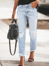 Distressed wash ankle jeans with light-wash denim, ripped knees and frayed hems