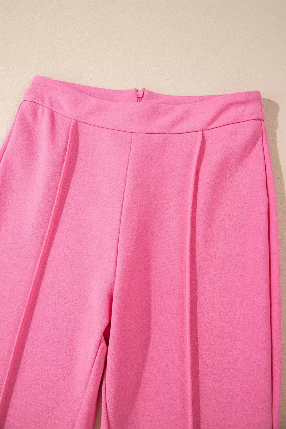 Bright pink High-Waisted Bootcut Pants with pleats and smooth fabric