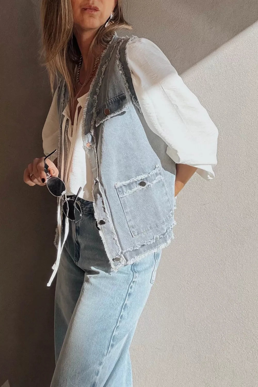 Light-wash frayed edge denim vest jacket with flap pockets and buttons
