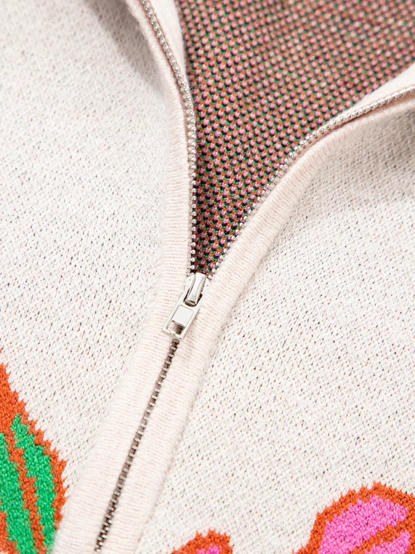 White and orange floral knit quarter zip sweater with silver zipper