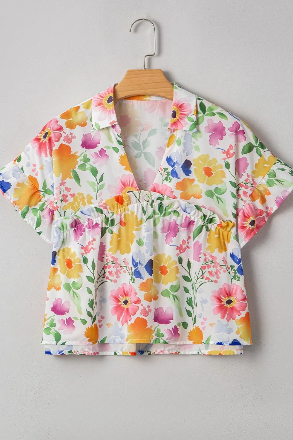 Floral boxy fit ruffled short sleeve blouse with vibrant blossoms